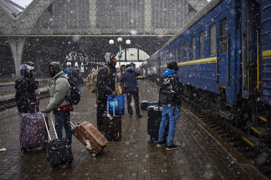 Nigerian students in Ukraine wait on a platform in Lviv railway station for a train to evacuate across the border, Sunday, February 27, 2022 in Lviv, west Ukraine.