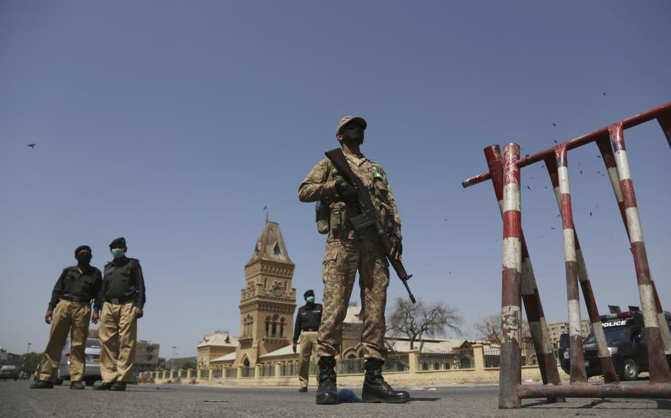 Soldiers and police stand guard during a lockdown to help stop the spread of the coronavirus, Karachi, Pakistan, March 3, 2020. 