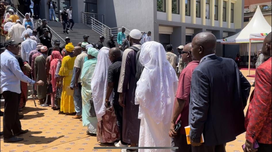 Victims and their families of crimes committed during Guinea’s 2009 stadium massacre line up to enter a courthouse in Conakry, Guinea.