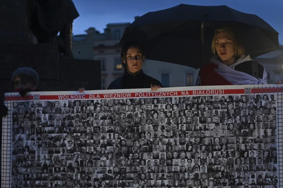 Members of the Belarusian diaspora outside the Adam Mickiewicz monument in Krakow, Poland.