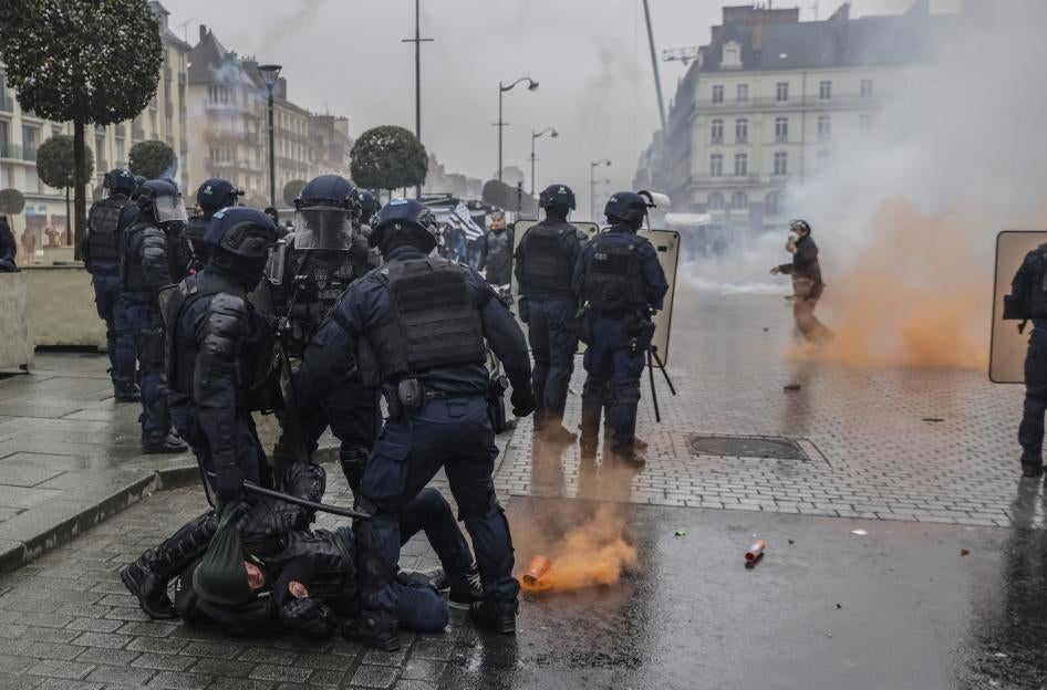 Riot police scuffle with protesters during a protest in Rennes, France.
