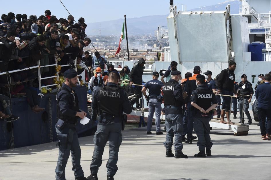 People disembark from a rescue ship in the Italian port of Catania.