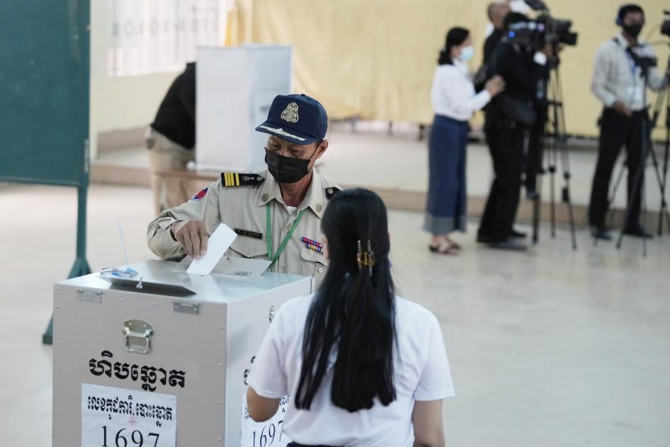A police officer drops his ballot at a polling station in Takhmau in Kandal province, southeast of Phnom Penh, Cambodia, June 5, 2022.