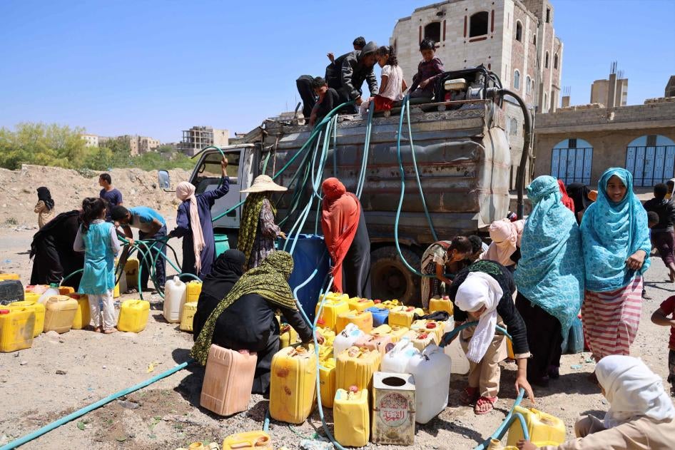 A group of women and children get water from a water truck in the Osaifera area, Taizz, March 7, 2023. 