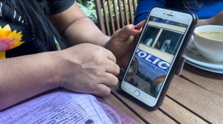 A woman displays a video on her phone
