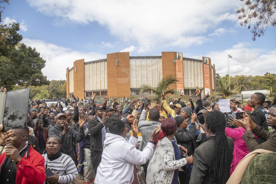 Opposition supporters protest outside a court, in Harare, Zimbabwe