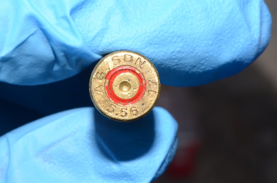A person holds up a bullet casing