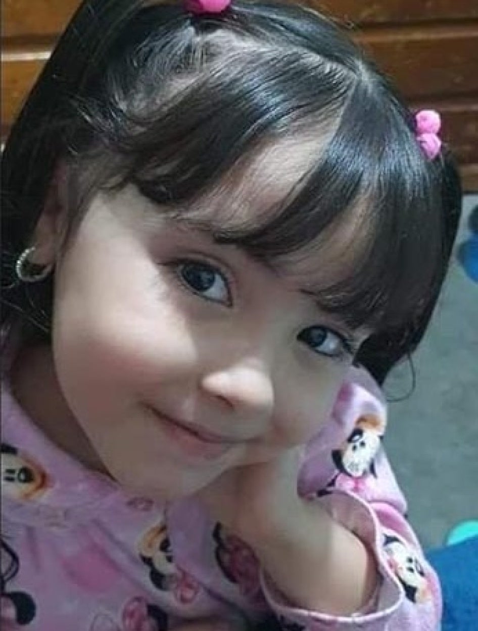 A young girl smiling in a photo