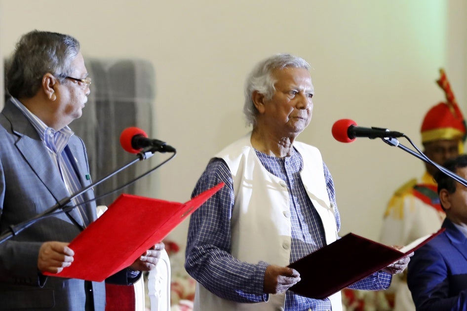 Nobel laureate Muhammad Yunus, right, takes the oath of office as the head of Bangladesh's interim government in Dhaka, Bangladesh, August 8, 2024.