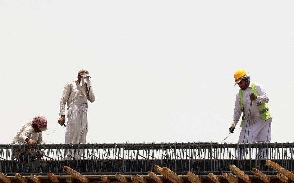 Migrant workers at a construction site amid scorching heat