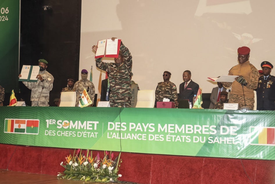Les dirigeants du Niger, le général Abdourahamane Tiani (au centre), du Mali, le colonel Assimi Goïta (à gauche), et du Burkina Faso, le capitaine Ibrahim Traoré (à droite), montrent les documents de l'Alliance des États du Sahel qu'ils ont signé lors de leur première réunion à Niamey, au Niger, le 6 juillet 2024.
