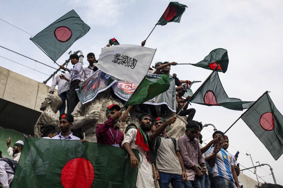 A group of people waving flags at a protest