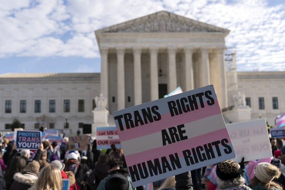 Transgender rights supporters rally outside of the Supreme Court in Washington, DC, US,  December 4, 2024.
