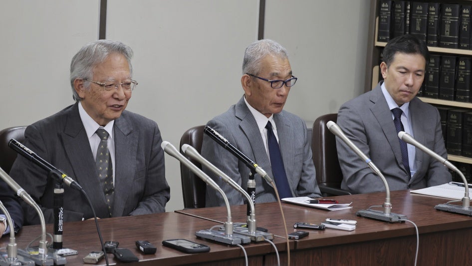 Three men attend a press conference