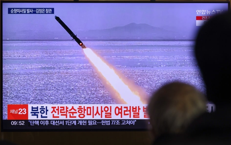 A TV shows a missile launch.