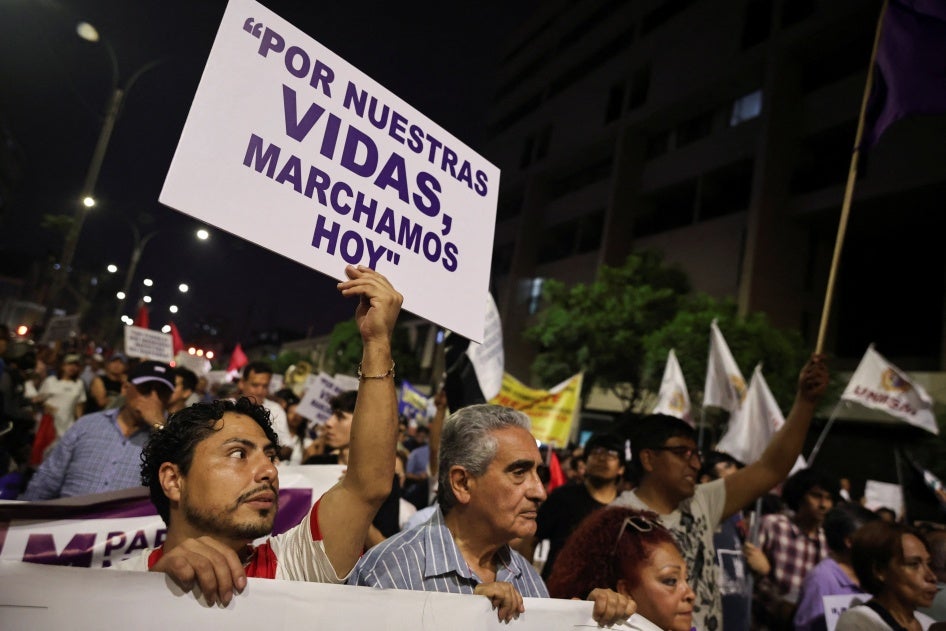 A demonstrator holds a sign which reads, "For our lives, we march today", as people attend a protest against crime and insecurity