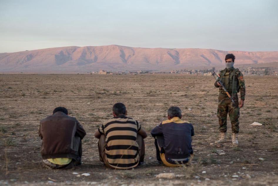 Three suspected ISIS members who travelled alongside families escaping areas around Mosul recently retaken from the group are held by KRG’s security forces at a checkpoint east of the city. November 4, 2016. 