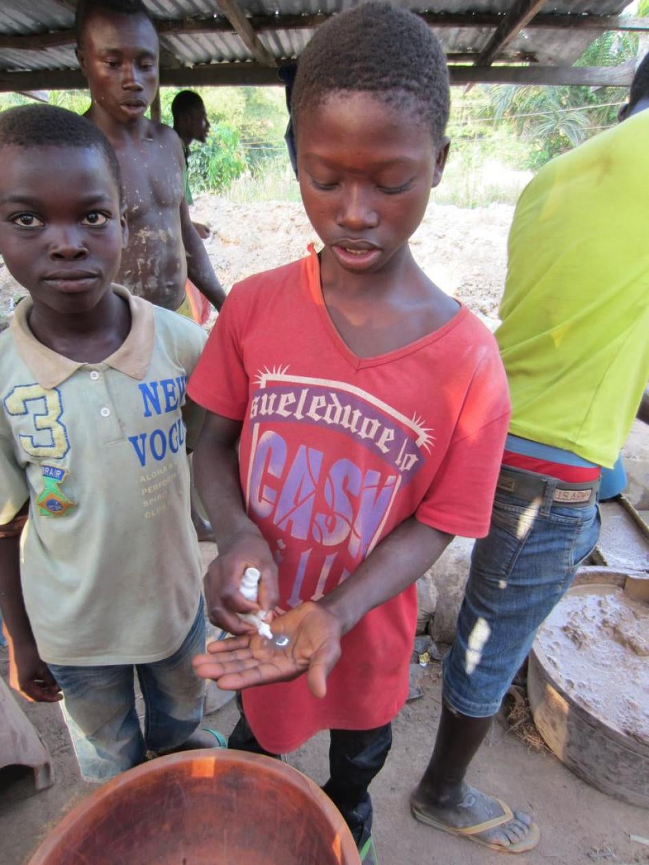 A 12-year-old boy shows the mercury he carries in his trousers’ pockets for gold processing in Homase, Amansie Central district, Ashanti Region, Ghana.