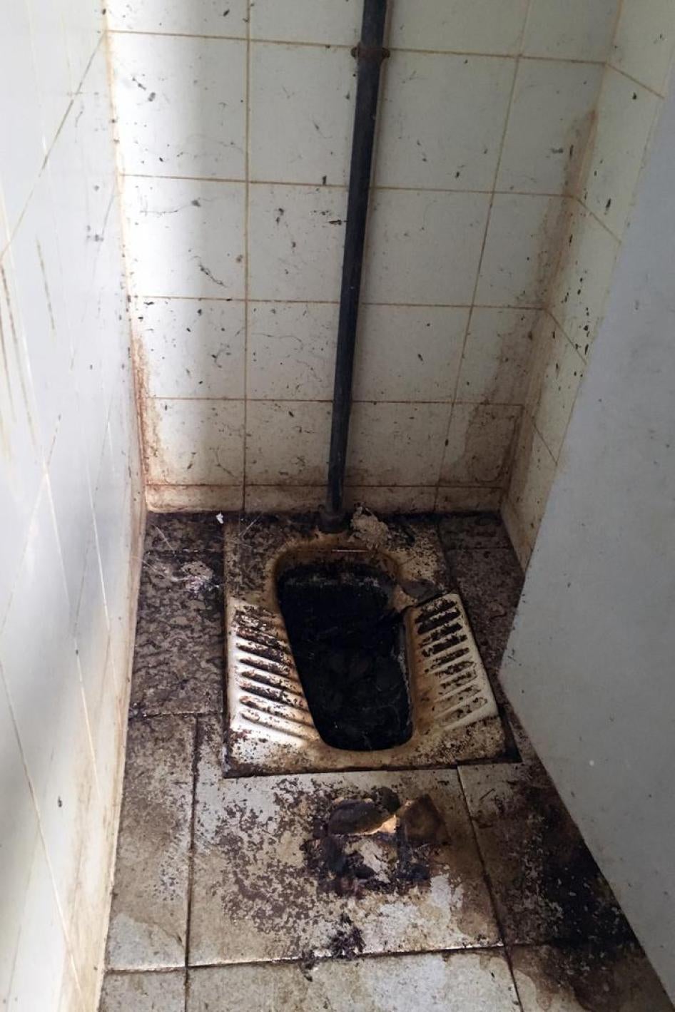 A bathroom at the high school, where there is no running water.