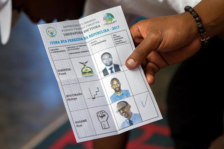 A polling staff member displays a ballot at a polling center in Kigali, Rwanda, August 4, 2017. 