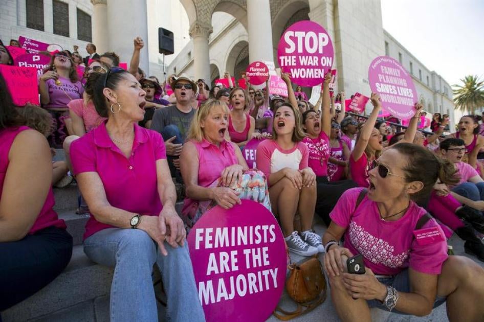 Activists chant as they rally in support of Planned Parenthood on "National Pink Out Day" on the steps of City Hall in Los Angeles, California on September 29, 2015.