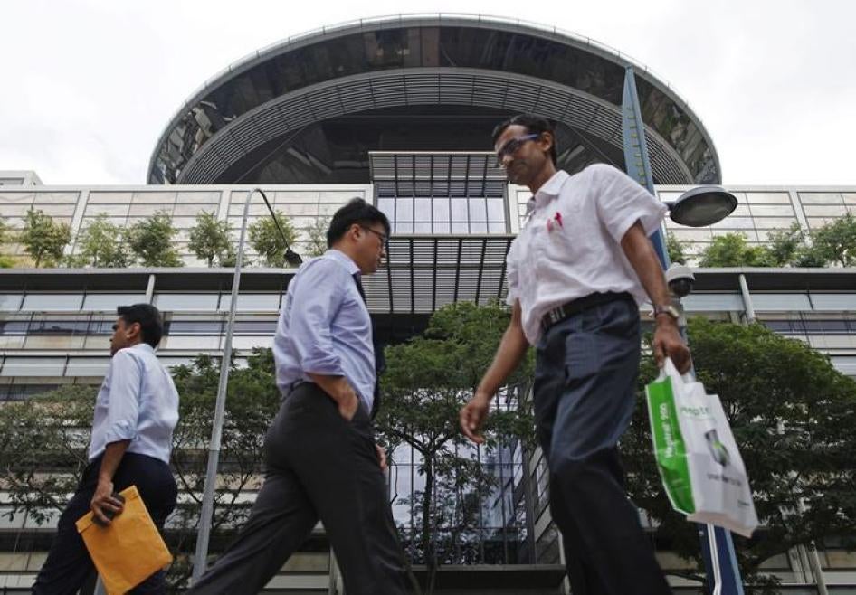 People walk past the Supreme Court in Singapore January 22, 2014.