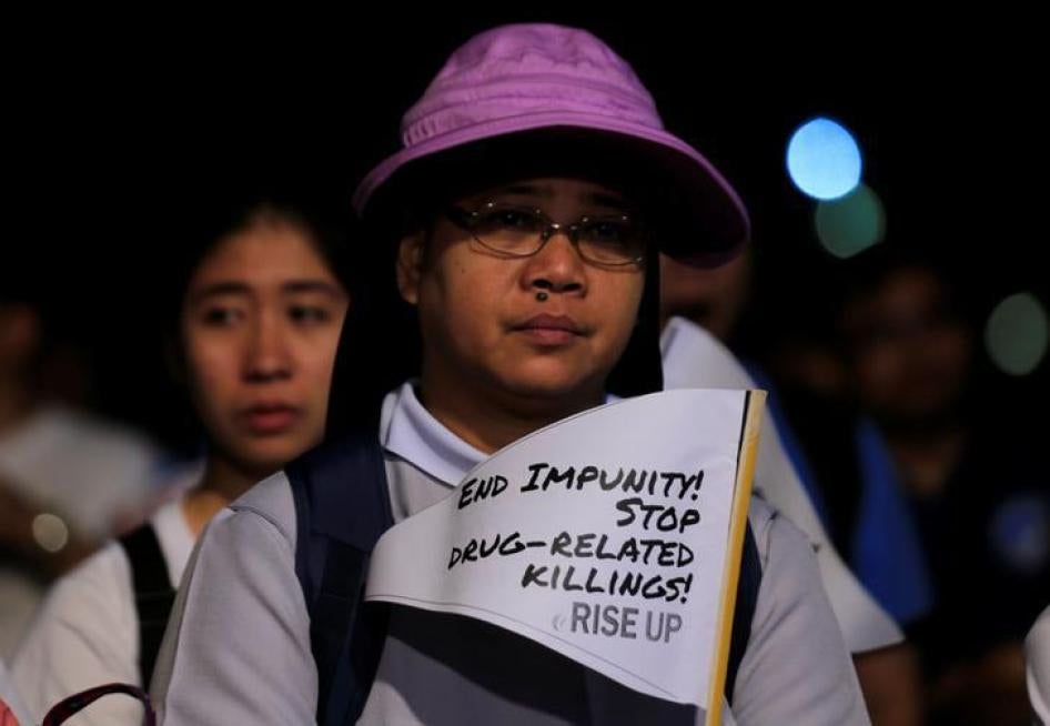 A Catholic nun displays a placard as she participates in a procession against plans to reimpose death penalty and intensify drug war during "Walk for Life" in Luneta park, Metro Manila, Philippines February 24, 2018. REUTERS/Romeo Ranoco