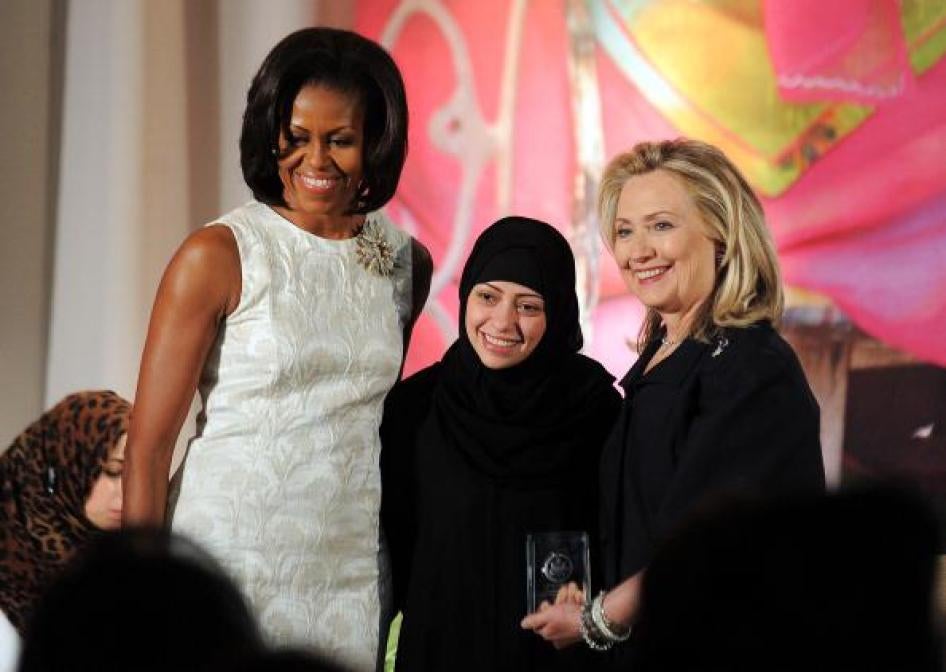 Former US First Lady Michelle Obama and former Secretary of State Hillary Clinton pose with Samar Badawi of Saudi Arabia as she receives the 2012 International Women of Courage Award during a ceremony at the US State Department in Washington, DC, on March