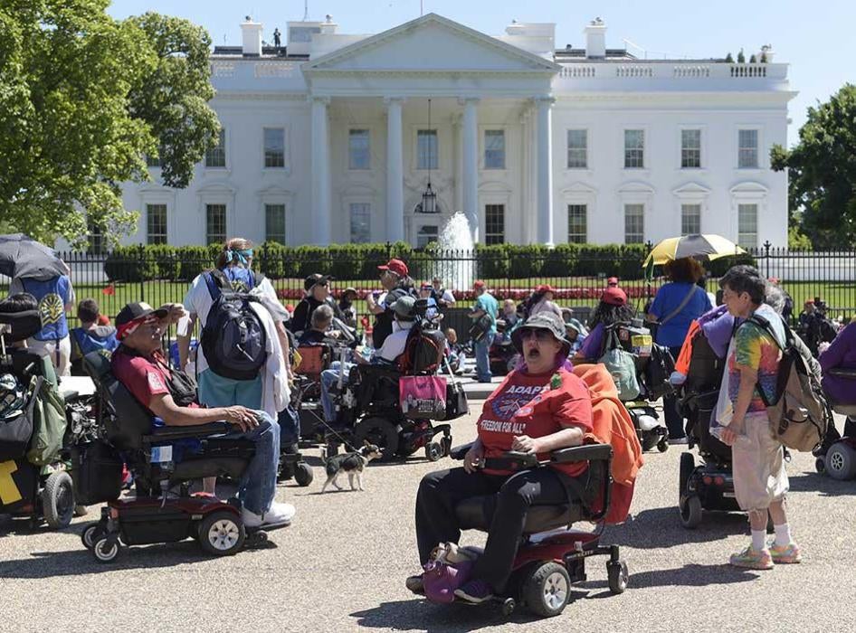 Protesters supporting people with disabilities gather outside the White House in Washington.
