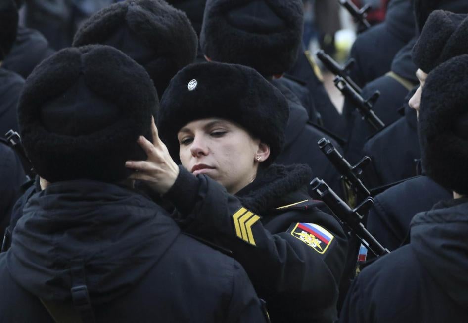 A Russian Marine Corps sergeant adjusts the hat of a conscript during an oath-taking ceremony in the Black Sea port of Sevastopol.