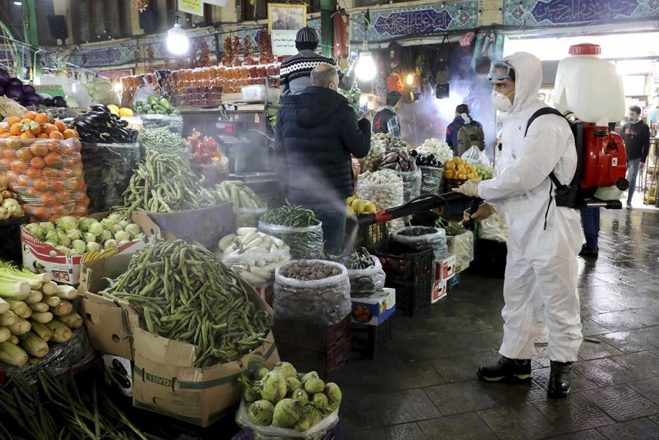 A firefighter disinfects a traditional shopping center to help prevent the spread of the new coronavirus in northern Tehran, Iran.