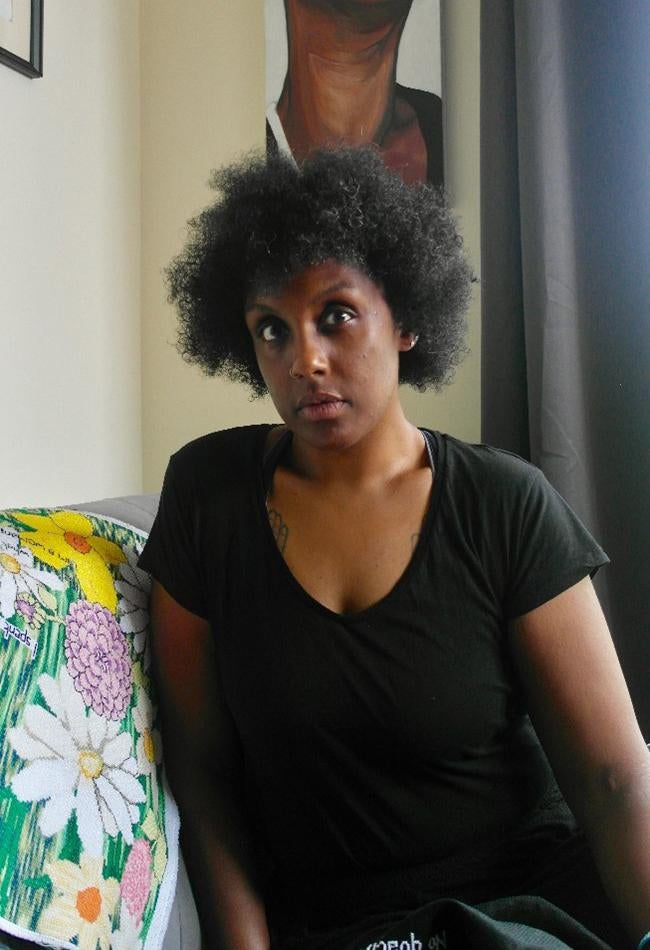 A woman in a black t-shirt poses for the camera