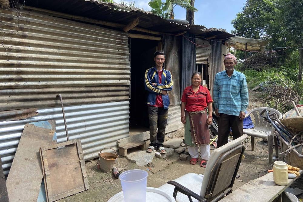A family stands in front of their home