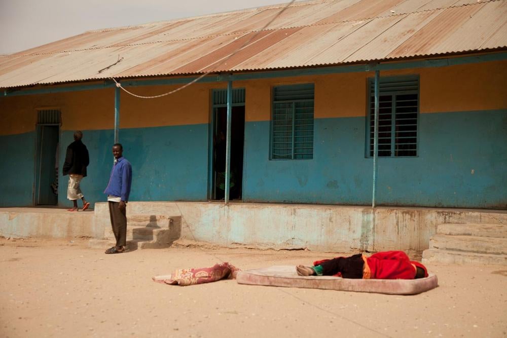 patient sleeps on a mattress in the open yard