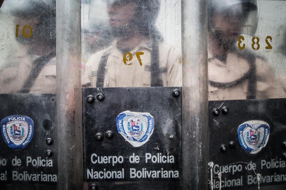 Agentes de la Policía Nacional Bolivariana, detrás de sus escudos, bloquean la calle durante una manifestación contra el gobierno en el Boulevard de Sabana Grande, Caracas, 12 de mayo de 2017.