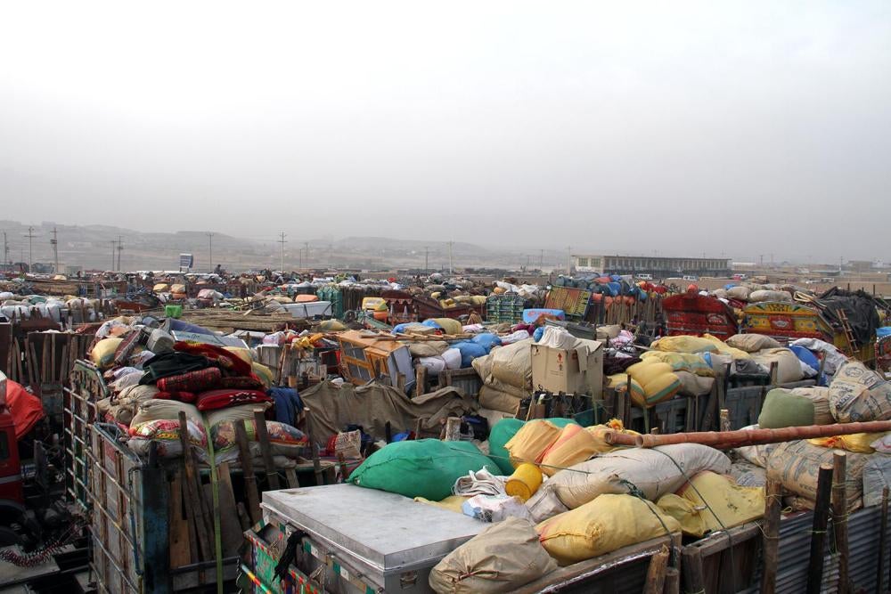 Trucks hired by Afghan refugees forced out of Pakistan after living there for decades line up at the UN refugee agency’s support center outside Kabul, packed with their belongings, October 2016.  At the height of the refugee exodus in October, hundreds of