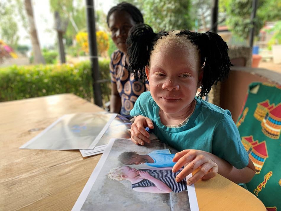 Josina, featured in Human Rights Watch's report "From Cradle to Grave," looks at photos of herself and her niece in Mozambique.