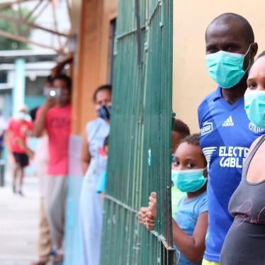 Families wearing masks wait outside their homes in the neighborhood of Cristo del Consuelo for food handouts from the local government in Guayaquil, Ecuador, April 14, 2020.