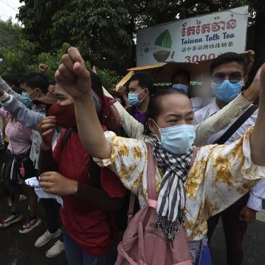 Supporters of Rong Chhun, president of the Cambodian Confederation of Unions, shout slogans in front of Phnom Penh Municipal Court in Phnom Penh, Cambodia, Saturday, Aug. 1, 2020. 