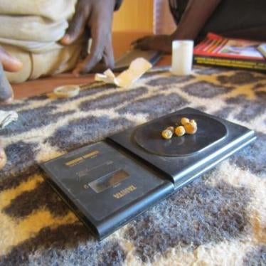 Gold nuggets being weighed by a gold trader