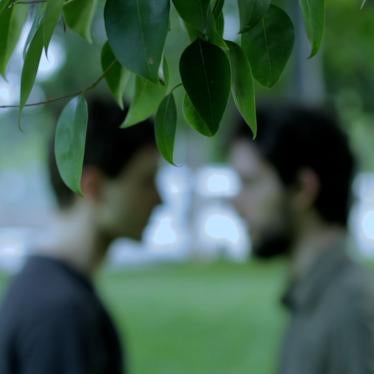 Two men talking in park