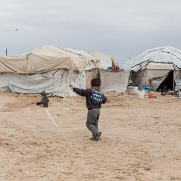 A boy flies a home-made kite in the foreigners’ section of al-Hol camp in northeast Syria on March 15, 2021.