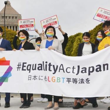 Supporters of Equality Act Japan gather in front of parliament before they submit a petition in Tokyo on March 25, 2021. 
