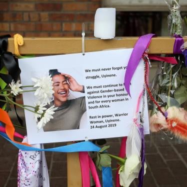 A memorial sign surrounded with ribbons and flowers