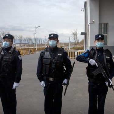 Police officers stand at the outer entrance of the Urumqi No. 3 Detention Center in Dabancheng in western China's Xinjiang region on April 23, 2021.