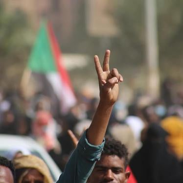 Pro-democracy protesters flash the victory sign as they take to the streets to condemn a takeover by military officials, in Khartoum, Sudan, October 25, 2021. 
