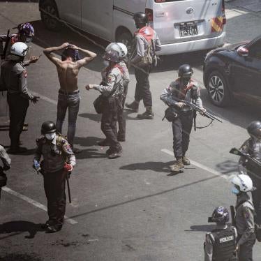 Aerial image of uniformed police officers detaining a protester 