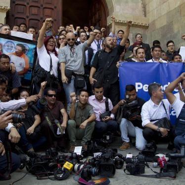 A group posing for a photo with raised fists
