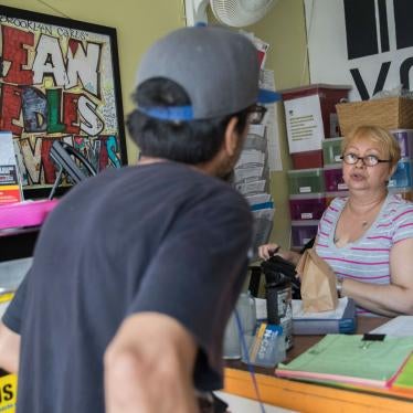 Evelyn Milan, right, prepares a package with sterile injecting equipment for a member at VOCAL-NY's headquarters in the Brooklyn borough of New York, June 3, 2018. 