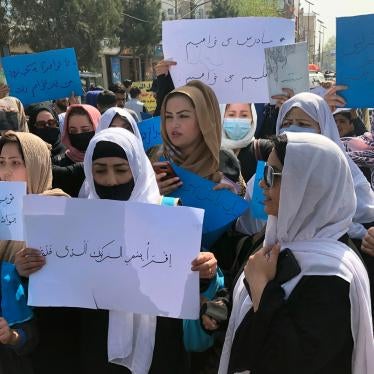 Women chant and hold signs at a protest